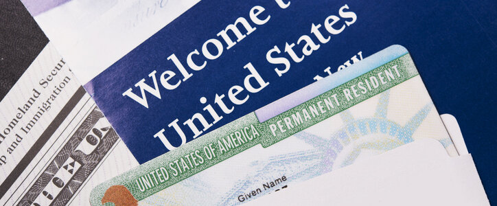 Welcome to the USA. Immigration Welcome Letter and Green Card Closeup. United States Homeland Security.