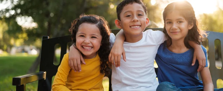 3 smiling immigrant children